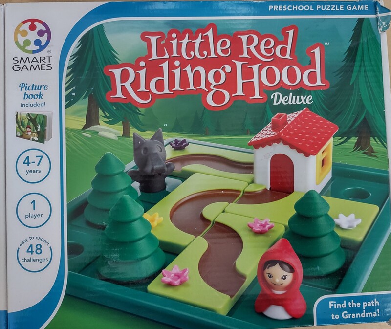Little Red Riding Hood Deluxe Skill-Building Board Game with Picture Book. SmartGames Little Red Riding Hood is an enchanting puzzle game for young children. Can you help Red Riding Hood find Grandma’s house in the forest? Can you out-smart the wolf when he appears? 

Play Little Red Riding Hood by arranging the puzzle pieces on the gameboard so that a direct path is created from Red Riding Hood to Grandma's house. Then, in the last 24 challenges, players have to create two paths: one for Red Riding Hood, and the other for the Wolf! A great introduction to Spatial Insight, Planning and Problem-Solving skills for kids.

Little Red Riding Hood also includes a family-friendly picture book with a SmartGames 'twist' on the original tale. Replacement value: $27